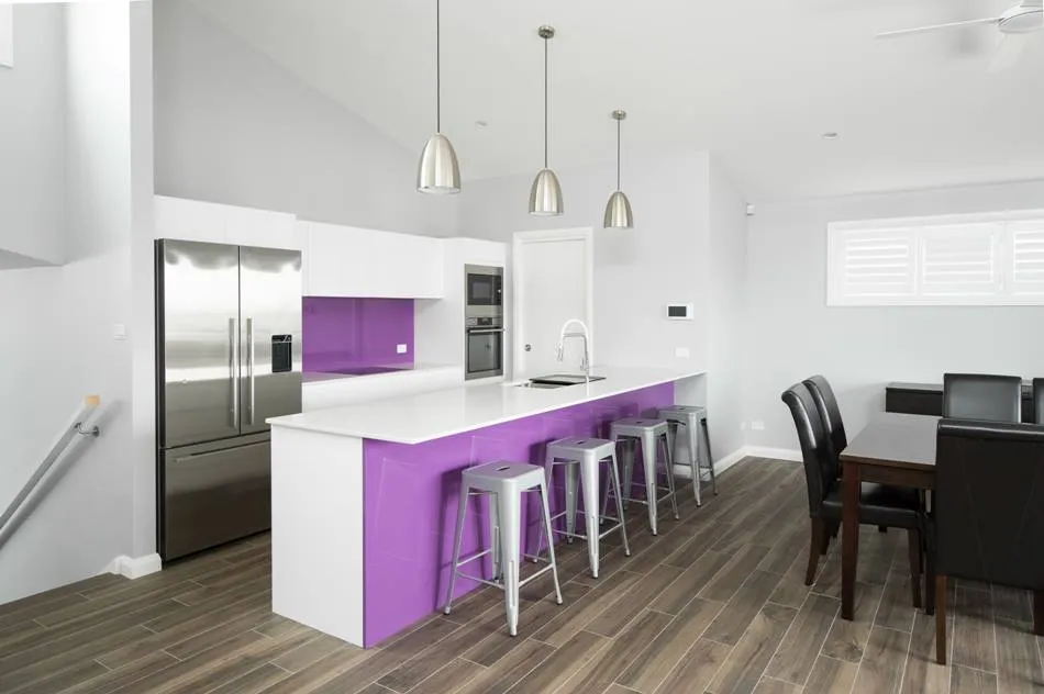 Renovated kitchen with island bench, pendant lights and stainless appliances