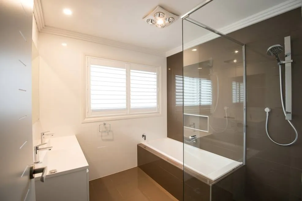 Renovated family bathroom with glass shower screen, bath and vanity